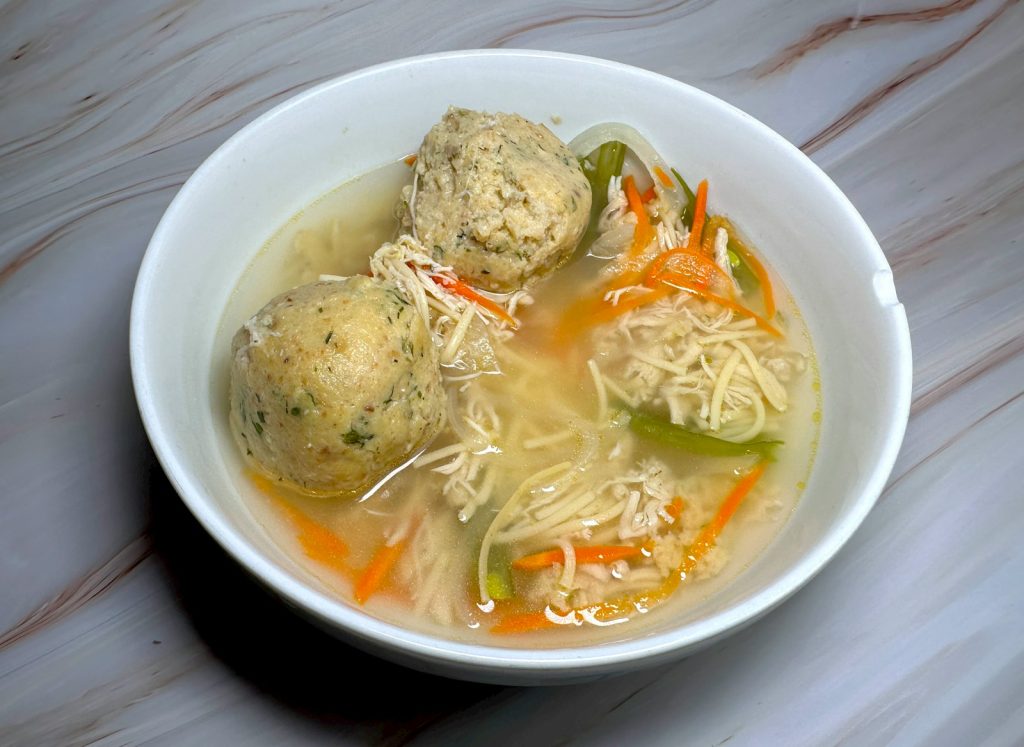 a bowl of soup with meatballs and vegetables